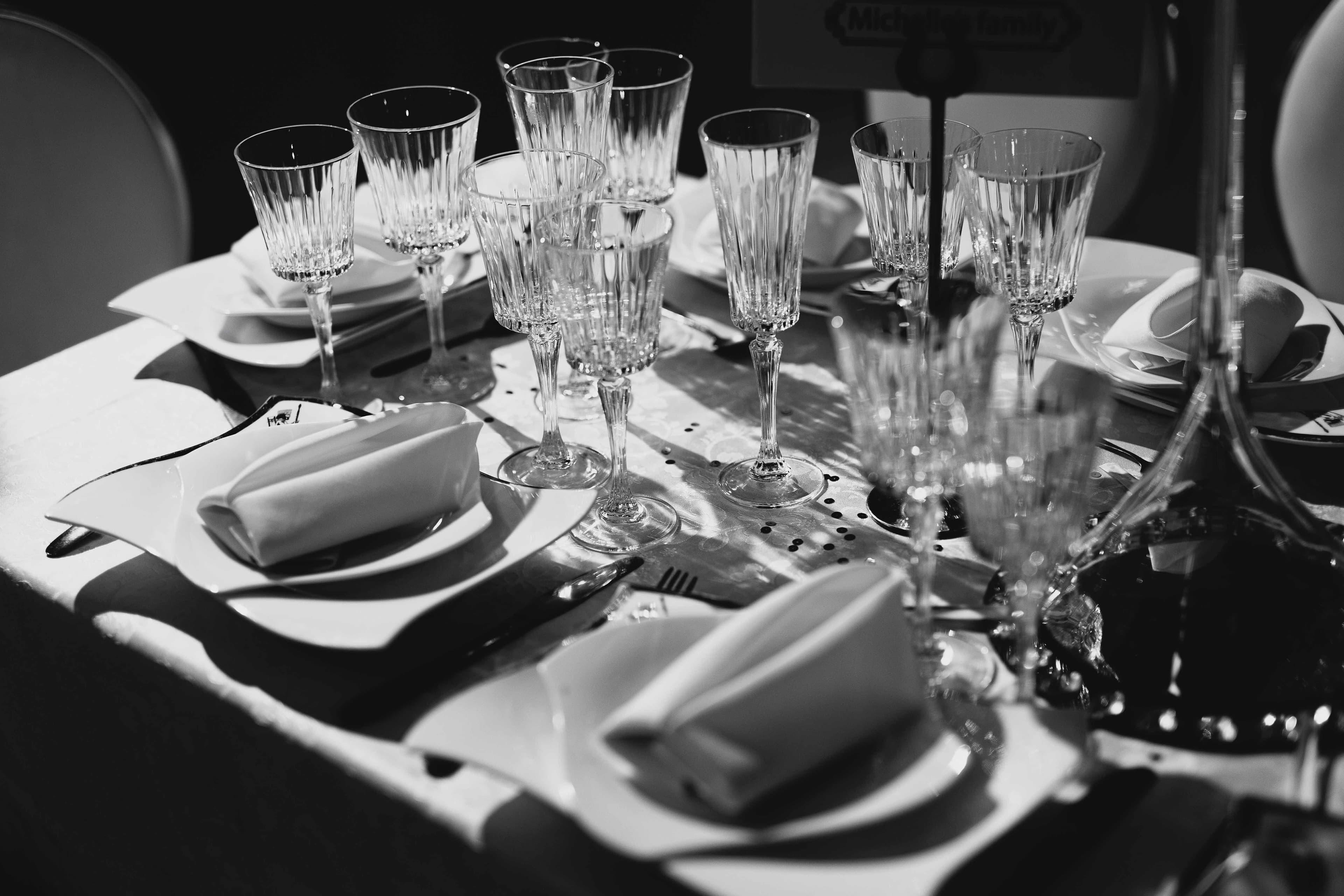A black-and-white crystal-and-china table setting at a MALKI gathering