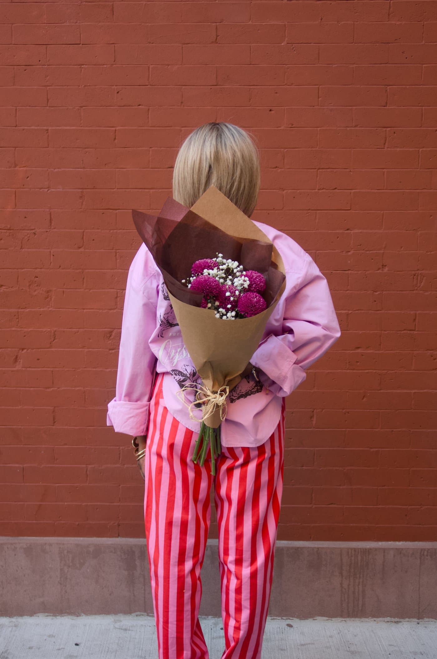 A MALKI look photographed against a red wall