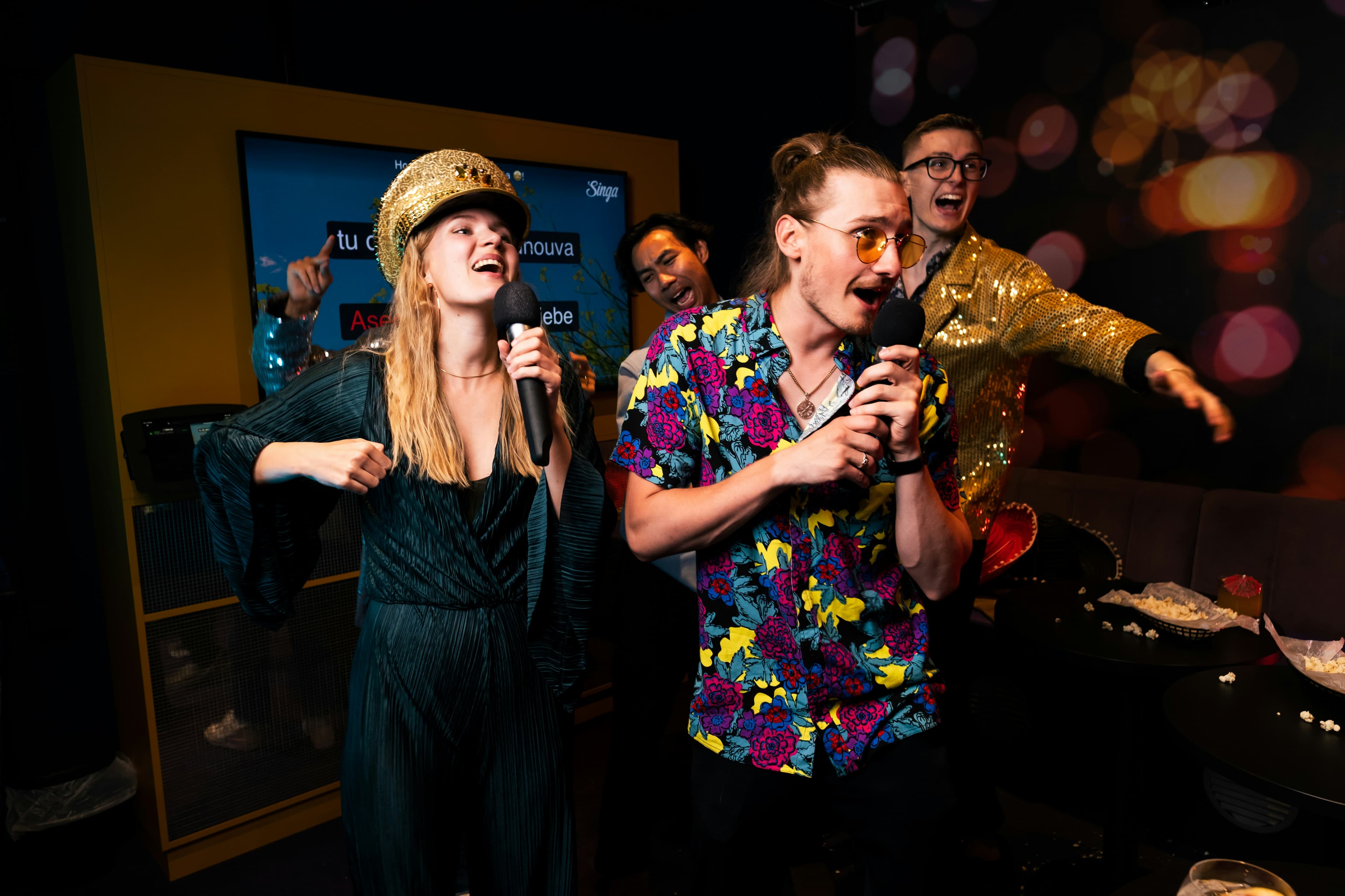 Friends singing together at karaoke