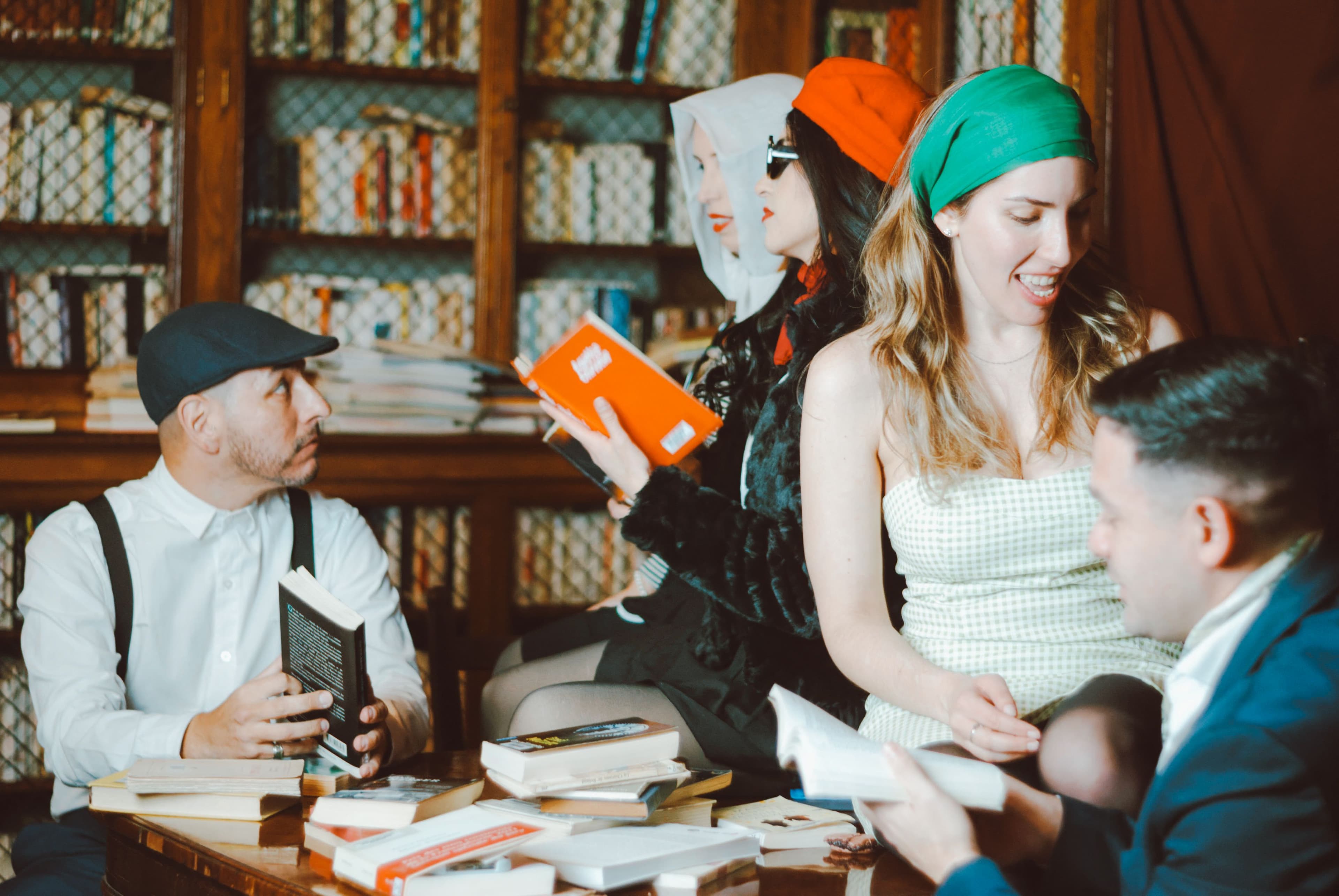 A conversation gathering among shelves of books