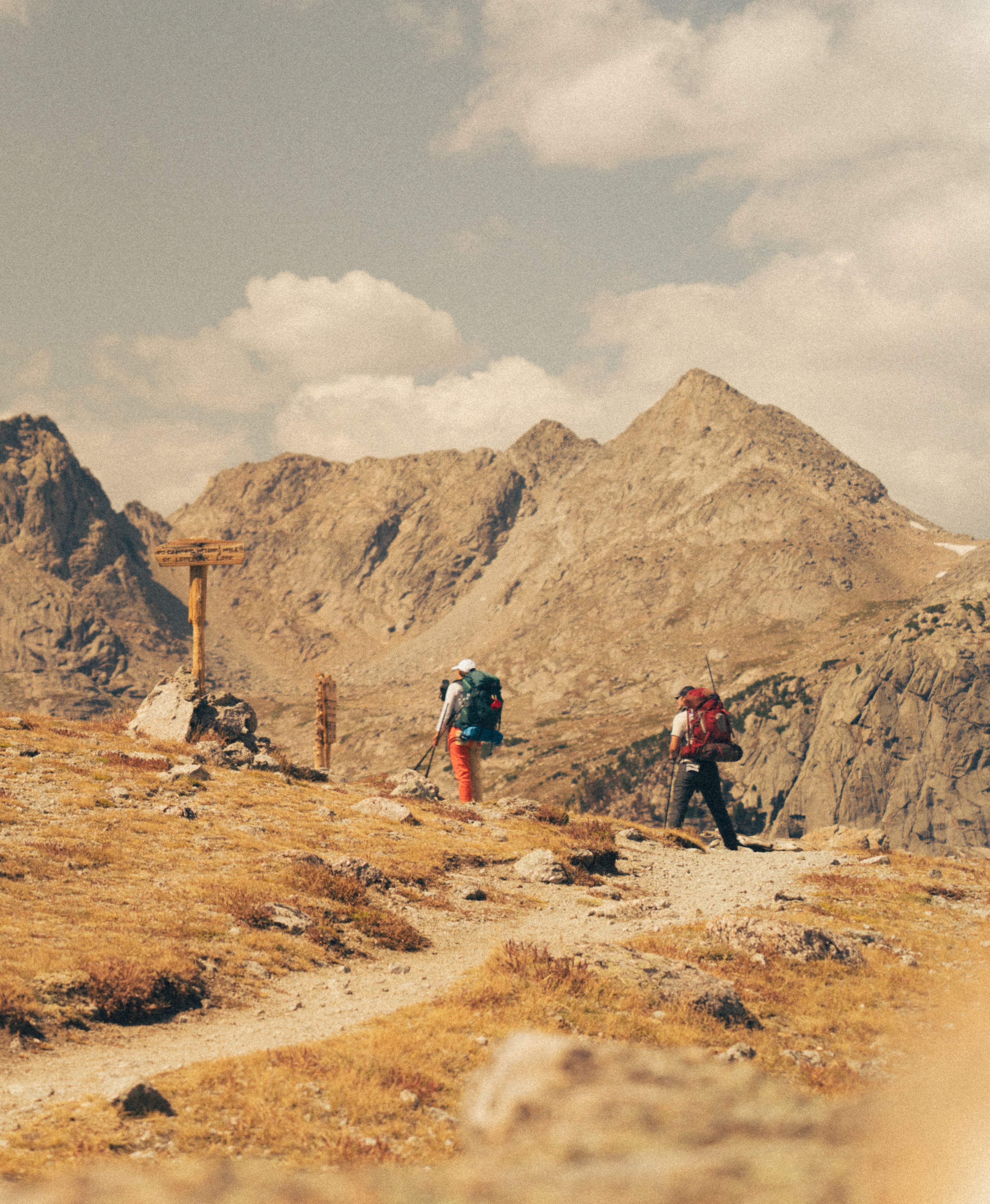 Two people hiking a mountain trail